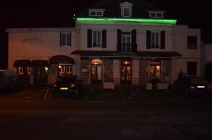 a building with a green light on top of it at Auberge du Lac in Marcilly-sur-Tille