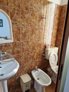 a bathroom with a sink and a toilet at Hotel Restaurant Savoja in Pogradec