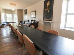 a conference room with a long table and chairs at Bodorgan Inn in Bodorgan
