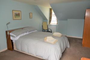a bedroom with a bed in a room at Grooms Cottage in Carsethorn