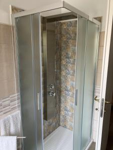a shower with a glass door in a bathroom at Dimora storica don Michele in Castelpagano