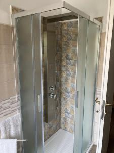 a shower with a glass door in a bathroom at Dimora storica don Michele in Castelpagano