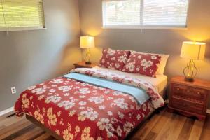 a bedroom with a red bed with two lamps at Cheerful 3-BR home near Downtown Dayton, Wright Patterson AFB and Airport in Dayton