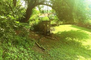 a yard with a tree and a bird cage at Cheerful 3-BR home near Downtown Dayton, Wright Patterson AFB and Airport in Dayton