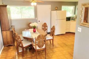 a dining room with a table and a refrigerator at Cheerful 3-BR home near Downtown Dayton, Wright Patterson AFB and Airport in Dayton