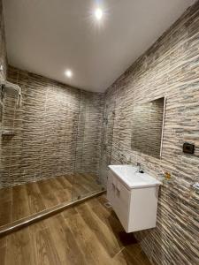 a bathroom with a white sink and a shower at Astoria in Casablanca