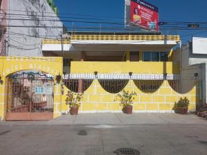 a yellow building with curtains on the side of it at Hotel Beatriz in Acapulco