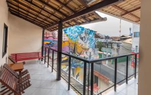 a mural on the side of a building with a bench at Dona Rosa Suites Privativas in Arraial do Cabo