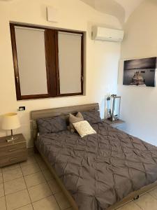 a bedroom with a bed in a room with a window at LakeView LakeComo 4Seasons, Terrace, 30m to Lake! by STAYHERE-LAKECOMO in Acquaseria