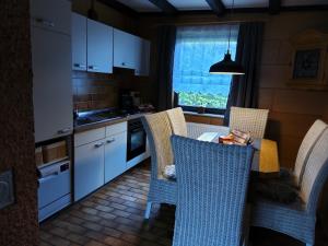 a kitchen with a table and chairs in a kitchen at Fewo Oehlenschlaeger Nr 53 Og in Arrach