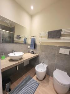 a bathroom with a white toilet and a sink at Lo Stellario di Lucca in Lucca +15 photos