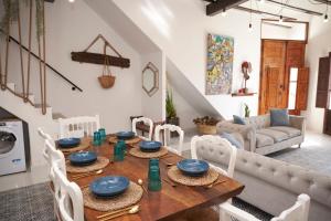 a living room with a wooden table and chairs at El mas allà in Chulilla