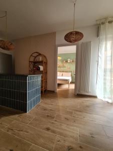 a living room with a wooden floor and a bedroom at La Boheme, 2 min da Qc terme, free parking in San Pellegrino Terme