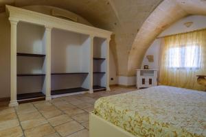 a bedroom with a large bed and a window at Casa vacanza Il Giglio in Manduria