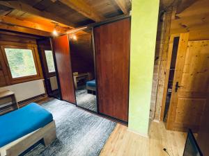 a small room with a door and a room with a window at Tantra klub - private room in a shared wooden house in Prague