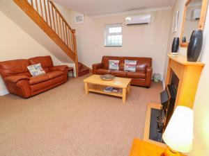 a living room with two couches and a table at Tynk in Saint Merryn