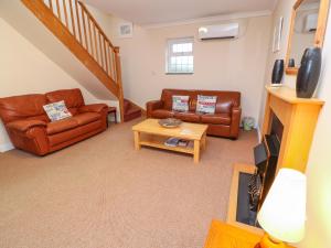 a living room with two couches and a table at Tynk in St Merryn