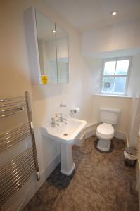 a bathroom with a white sink and a toilet at The Old Manse, Fochabers in Fochabers +24 photos