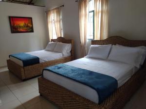 Postel nebo postele na pokoji v ubytování Casa Flórez Hotel Campestre