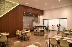 a restaurant with tables and chairs in a room at Pousada Flor de Alter in Alter do Chao