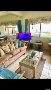 a living room with a couch and a table at Oceana Rosarito Condo Beach frontPrivately Owned downtown best views in Rosarito