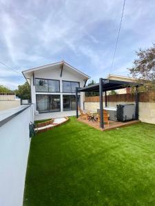 a house with a yard with green grass at Magnifique grange avec spa / love room in Saint-André-de-Cubzac