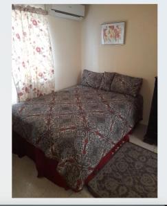 a small bedroom with a bed and a window at Chelsea Manor in Kingston