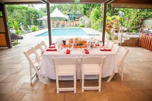 a table and chairs with a table and a pool at Hanalei Colony Resort in Hanalei