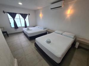 Postel nebo postele na pokoji v ubytování Hotel Vista Laguna Bacalar