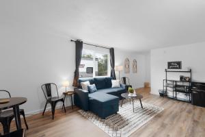 a living room with a blue couch and a table at Silver Sands Motel in Westport