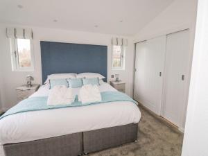a large bedroom with a large bed with blue walls at 1 Southern Place in Liskeard