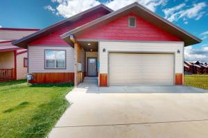 a red and white house with a garage at Villa Moreno in Pagosa Springs
