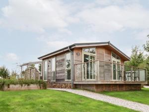 a large wooden house with a large deck at 11 Meadow Retreat in Liskeard