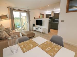 a living room with a dining table and a living room at 12 Meadow Retreat in Liskeard