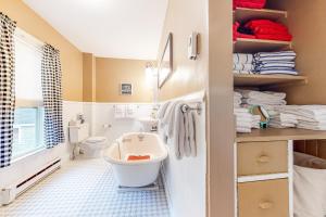 a bathroom with a white toilet and a sink at Pied-A-Terre in Kennebunkport +60 photos