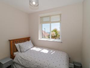 a bedroom with a bed and a window at Fisherman's Rest in Weymouth