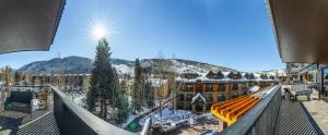a view from the balcony of a resort with snow covered mountains at Altus #206 in Vail