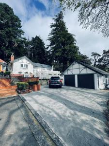 a car parked in front of a garage at Chatsworth Cottage in Upper Hutt