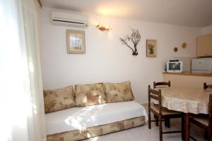 a living room with a couch and a table at Seaside holiday house Cove Rogacic, Vis - 8887 in Vis