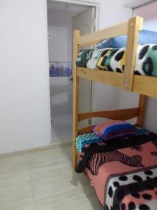 a room with two bunk beds and a mirror at Small House in Cusco