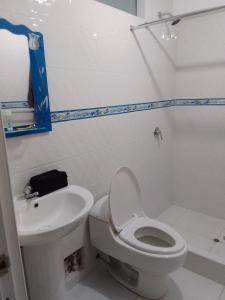 a bathroom with a toilet and a sink at Small House in Cusco