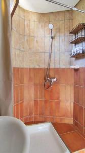 a bathroom with a shower with a toilet at Studio vue sur mer in Dar Bouazza