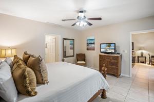 a bedroom with a bed and a ceiling fan at Ground-Floor Unit in Front of Lazy River Pool at Pacifico in Coco in Coco