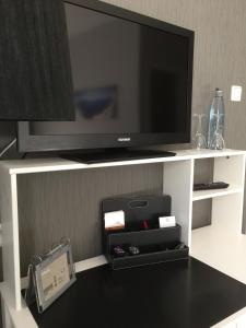 a flat screen tv sitting on top of a shelf at Hotel Achilles in Kirkel