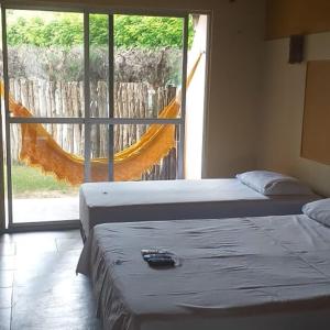 מיטה או מיטות בחדר ב-Pousada Nosso Recanto Camocim