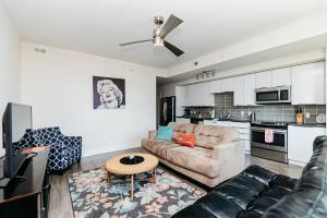 a living room with a couch and a kitchen at 1BR Uptown Charlotte Furnished Apartments apts in Charlotte