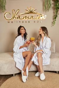 two women in white robes sitting on a couch at Hotel Pance 122 Wellness Spa in Cali