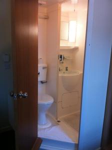 a bathroom with a toilet and a sink at Colliers Hotel in London