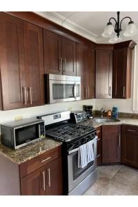a kitchen with a stove and a microwave at Grand Old White Capitol Executive Suite in Charleston