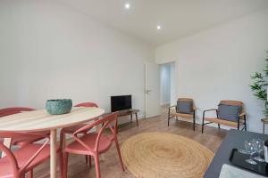 sala de estar con mesa, sillas y TV en Spacious & Light-Filled 4BR Apartment By TimeColer, en Amadora